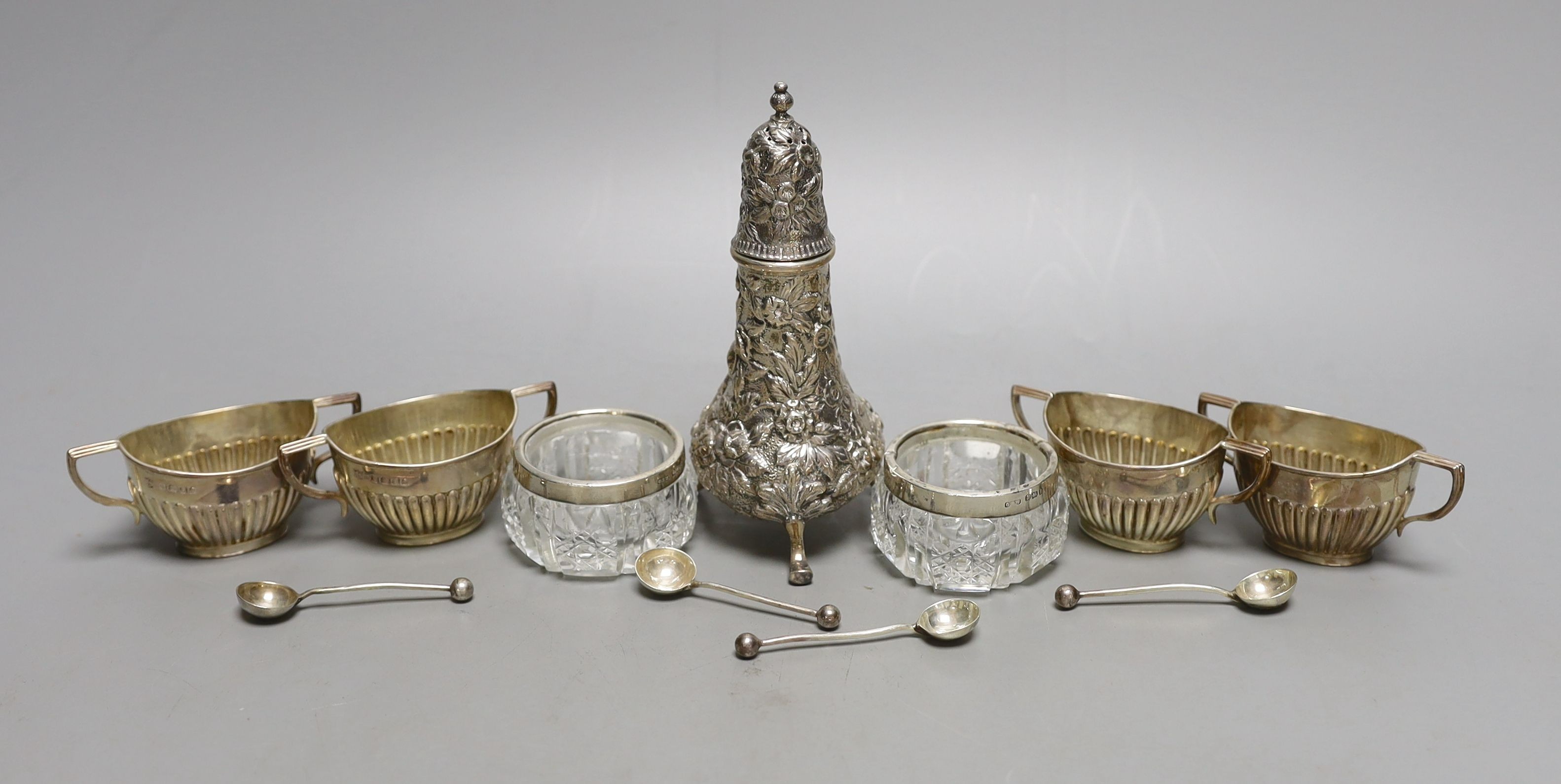 A set of four late Victorian demi-fluted silver salts and spoons, two other salts and a caster.
